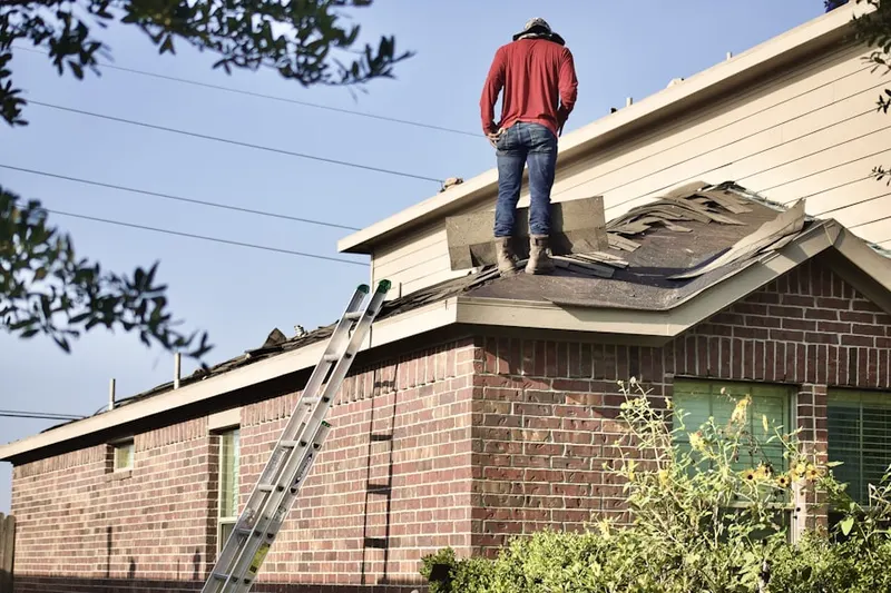 Professional roofer working on a residential roof in Northwest Industrial